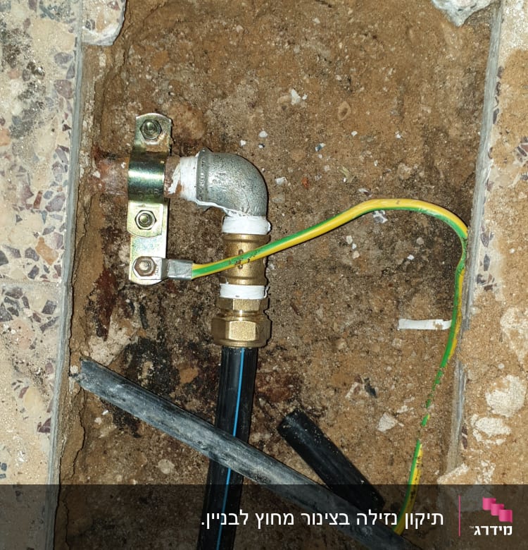 צינור מים עם חיבורי מתכת וחוטי חשמל